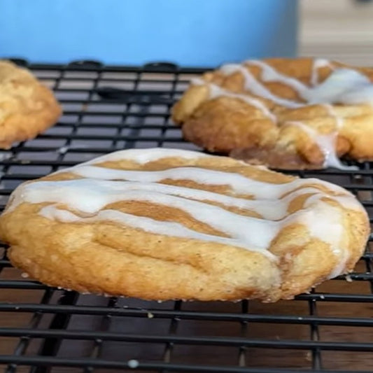 Cinnamon Sugar Cookies with frosting on a cooling rack.