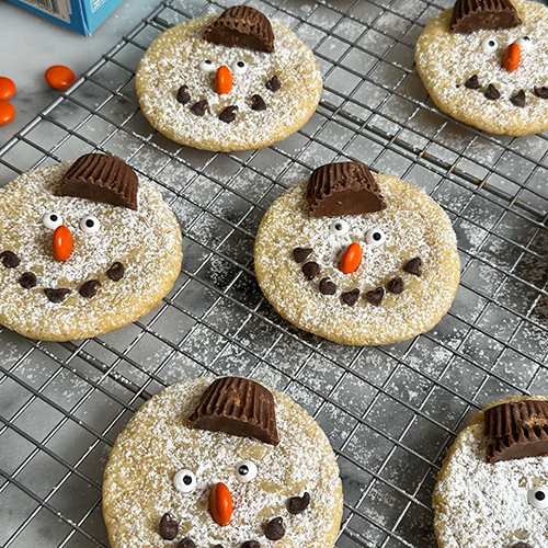 Snowman Sugar Cookies made with peanut butter cups, chocolate chips, and M&Ms.