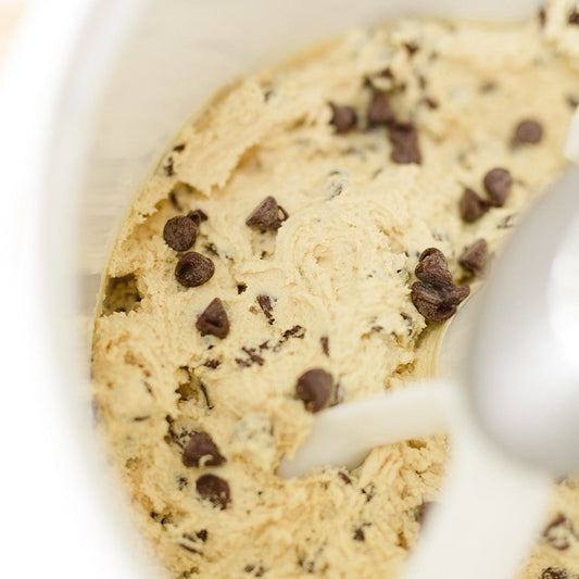 Cookie dough mixing in a stand mixer.
