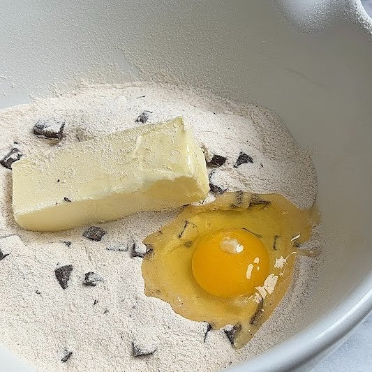 Baking ingredients including butter, eggs, and My Better Batch cookie mix.